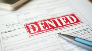 A big red denied stamp on an employment application.